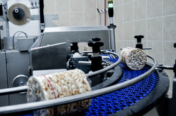 conveyor automatic tape for the production of useful whole-grain extruder crispbread. packing organic multi-barley briquetted crispbread on factory