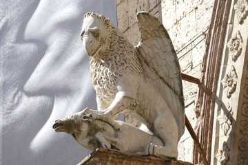 Portal of Palazzo dei Priori, Perugia. It is a gothic style portal with decorations and statues of lions and saints. It is situated in corso Vannucci, Perugia, Italy.