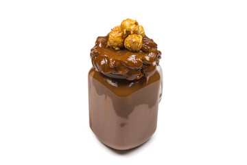 Chocolate milkshake with whipped cream, cookies, waffles, served in glass mason jar. 