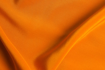 Golden silk or satin luxury fabric texture can use as abstract background.