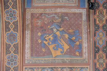 Interior of Notari Hall, Perugia. Interior of Notari Hall in Palazzo dei Priori has a vault supported by Romanesque arches decorated with gold-color frescoes depicting legends and biblical stories. It