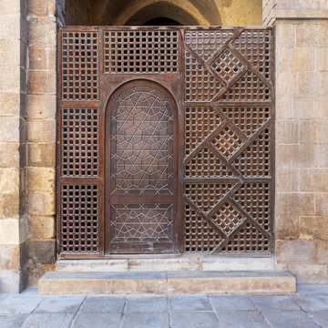 Interleaved wooden wall, known as mashrabiya, with wooden ornate door, Old Cairo, Egypt