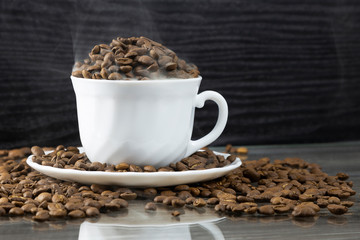 roasted black coffee is smoking in a cup.