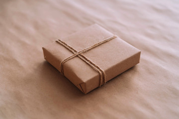 Gift box made of recycled paper on a craft background.