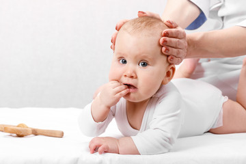 Little baby receiving osteopathic treatment of head and neck