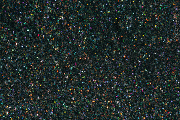 Texture made of black holographic sparkles. Creative party background.