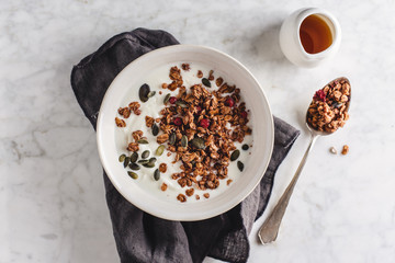 Homemade granola with yogurt in bowl
