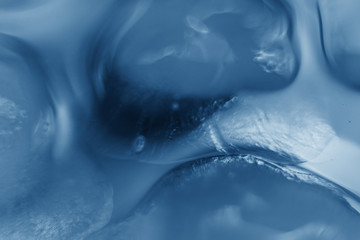 Ice cubes in a glass in blue classic 