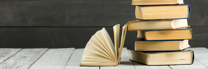 Open book, hardback books on wooden table. Back to school. Copy space