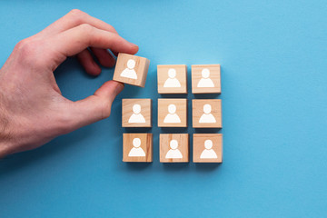 Hand adding a new team member to a group. Business management concept