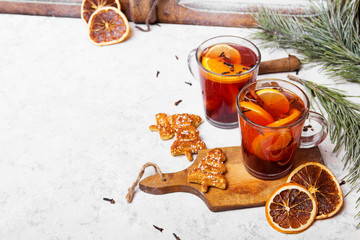 Christmas drink, mulled wine with orange, cinnamon and cloves on white background
