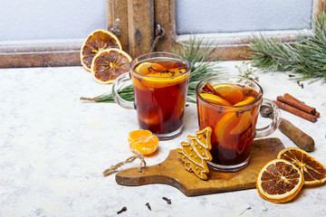 Christmas drink, mulled wine with orange, cinnamon and cloves on white background