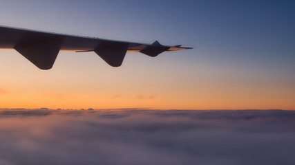 warm sunset from airplane and soft clouds