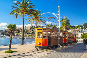 The famous orange tram runs from Soller to Port de Soller, Mallorca, Spain - obrazy, fototapety, plakaty