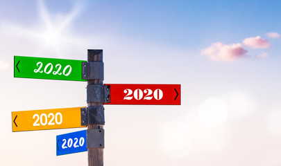 Fototapeta premium Signpost with 2020-Arrows in Different Colors