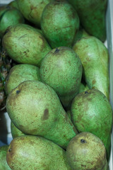 Tasty juicy pears in wooden box on market