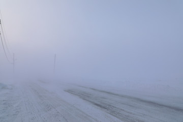 Road disappearing under blizzard conditions in Arviat, Nunavut Canada in winter conditions