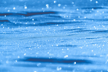 Christmas background of blue snow with bokeh effect, perfect for writing
