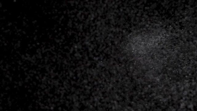 Epic drop sprinkling of silver glitter salt on glass, pov shot 