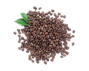 Coffee beans and green leaves on a white background.
