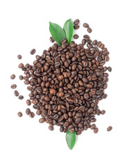Coffee beans and green leaves on a white background.
