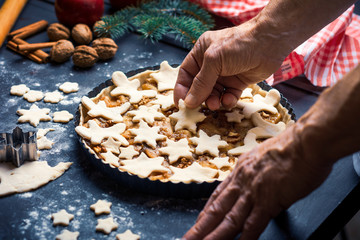 Senior making a festive decorated apple pie at home