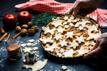 Senior holding homemade and festive decorated apple pie