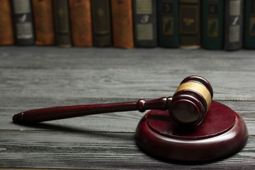 Obraz premium Law concept - Open law book with a wooden judges gavel on table in a courtroom or law enforcement office isolated on white background. Copy space for text.
