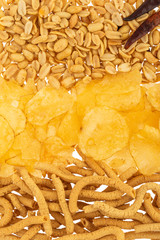 Golden fries peanuts and flour churritos on white background