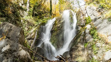 Beautiful waterfall in autumn forest. Krasnaya Polyana, Sochi, Russia.