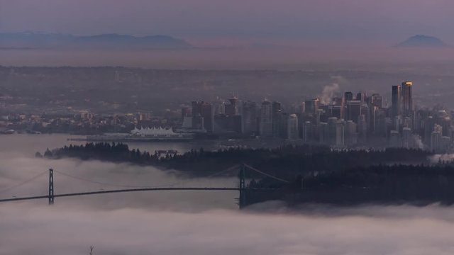 Cinemagraph Time Lapse of Downtown Vancouver City Buildings and Stanley Park View. Picture taken during a cloudy evening from Cypress Mountain Viewpoint, West Vancouver, British Columbia, Canada.