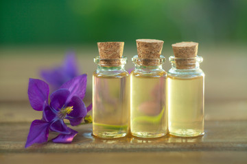 Essence of flowers on table in beautiful glass jar