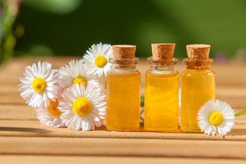 Essence of flowers on table in beautiful glass jar © solstizia