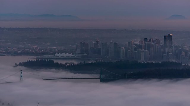 Cinemagraph Time Lapse of Downtown Vancouver City Buildings and Stanley Park View. Picture taken during a cloudy evening from Cypress Mountain Viewpoint, West Vancouver, British Columbia, Canada.