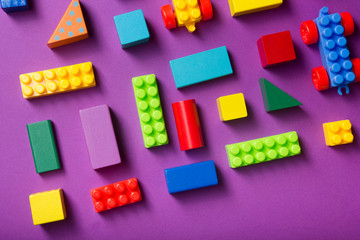 Colorful kids toys frame on wooden background. Top view. Flat lay. Copy space for text