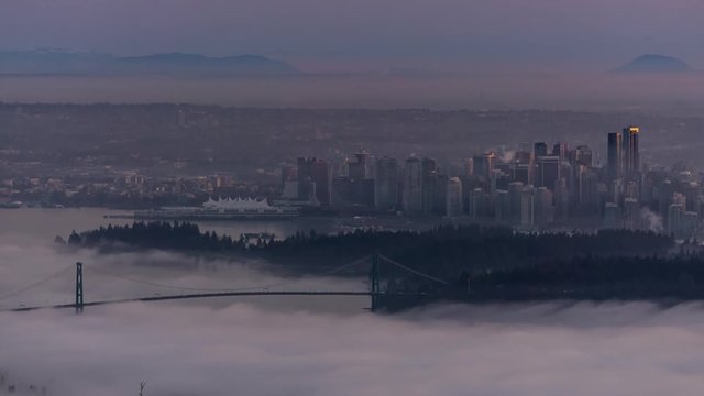 Time Lapse of Downtown Vancouver City Buildings and Stanley Park View. Picture taken during a cloudy evening from Cypress Mountain Viewpoint, West Vancouver, British Columbia, Canada.