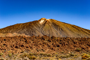Highest Peak Behind Arid Lava Rocks On A Sunny And Very Clear Day In El Teide National Park. April 13, 2019. Santa Cruz De Tenerife Spain Africa. Travel Tourism Street Photography.