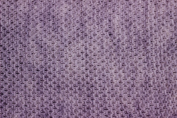 Knitted woolen background. The texture of light blue wool close-up. Knitted fabric, handmade, machine knitting.