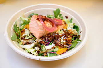 Healthy meal with salmon, salad and soy sauce