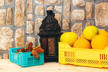 Dates and orange, lemon on basket , Oriental Lamp, Lantern. Arabic Holidays Concept