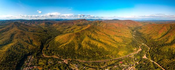 the beginning of golden autumn in the mountains of the Western Caucasus - big aerial panorama of...