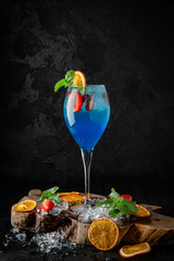 Cocktail blue lagoon. Cocktail card.  Background black boards.