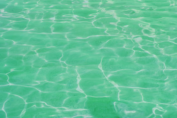 surface of green swimming pool. Background water in sea.