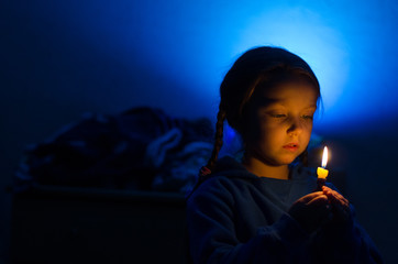 Girl with a candle blue background