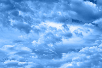 Classic blue background. Sky with clouds, copy space. Color of the year 2020. Nature heaven background