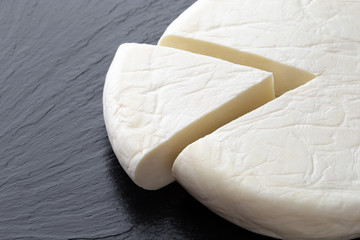 Cheese on a slate surface. Piece of cheese close-up.