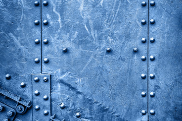 Abstract metal texture with bolts and rivets, copy space. Classic blue background. Color of the...