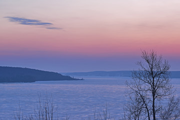 Winter landscape of frozen Lake Superior at dawn, Munising, Michigan, USA