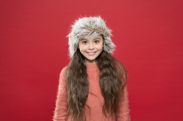 Warm clothes and accessory tips. happy little girl in earflap hat. holiday activity outdoor. small child ready for winter. seasonal health care. kid fashion. Fashionable and warm essentials