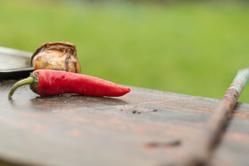 a pod of red pepper lies on a wooden table1